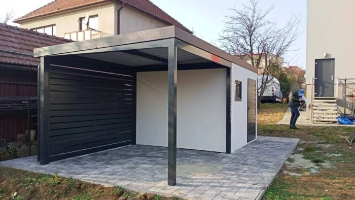 Montovaný záhradný domček s prístreškom, dverami a oknom, postavený v záhrade